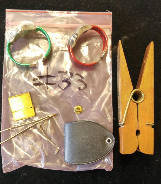 Bag of miscellaneous treasure; Watches, tweezers, clip, magnifying glass, etc.
